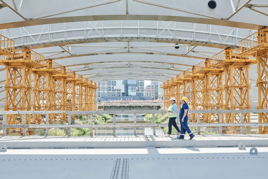 Two workers walking through a facility