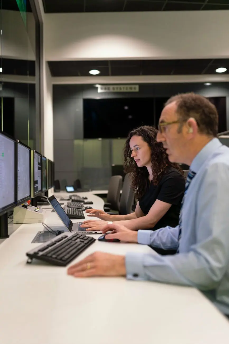 Operators reviewing reports on screens